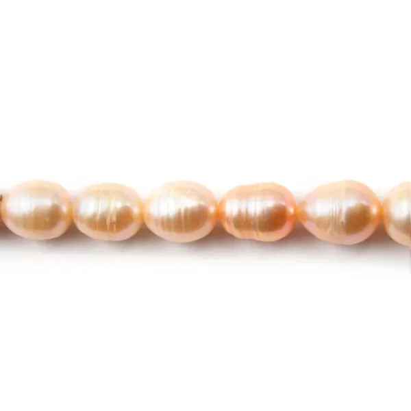 Perles d'eau douce ovales couleur saumon sur fil 6-6.5mm x 40cm