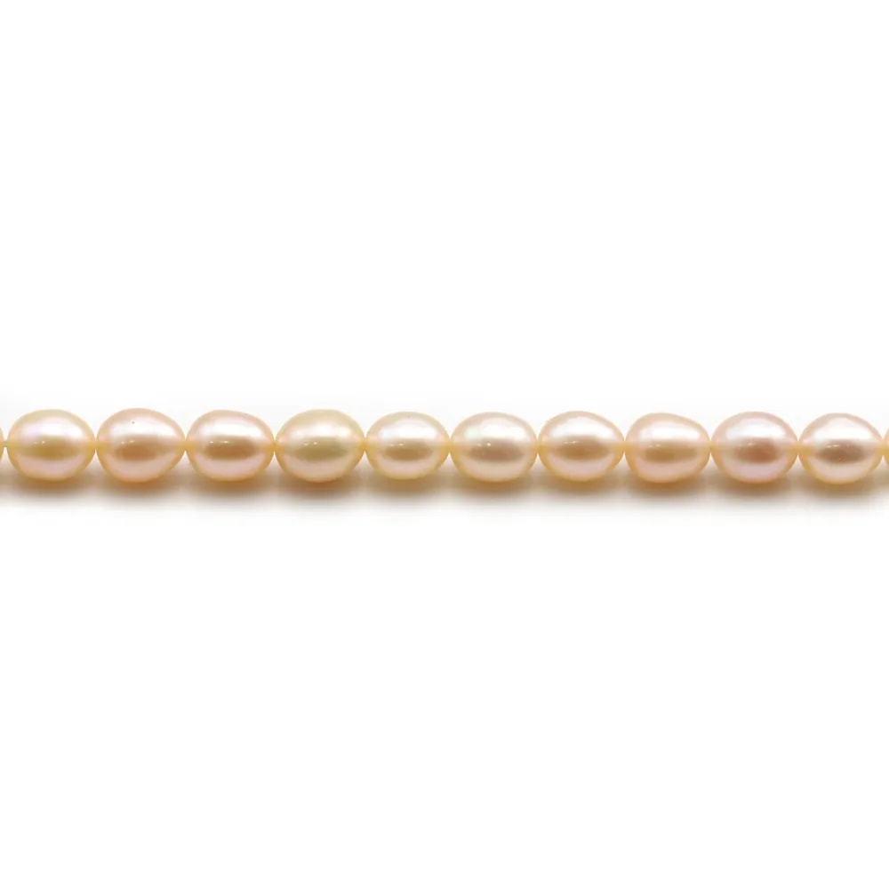 Perles d'eau douce ovale couleur saumon sur fil 5-6mm x 40cm