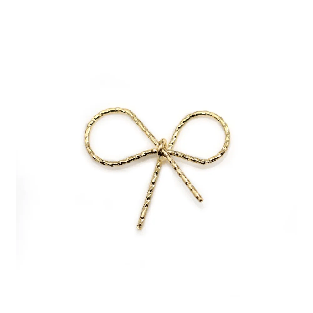 Breloque en forme noeud papillon, plaqué par "flash" or sur laiton 19mm x 4pcs